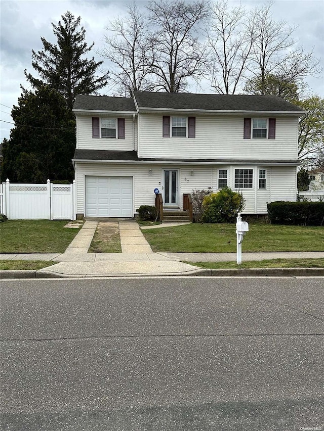 raised ranch featuring a front lawn and a garage