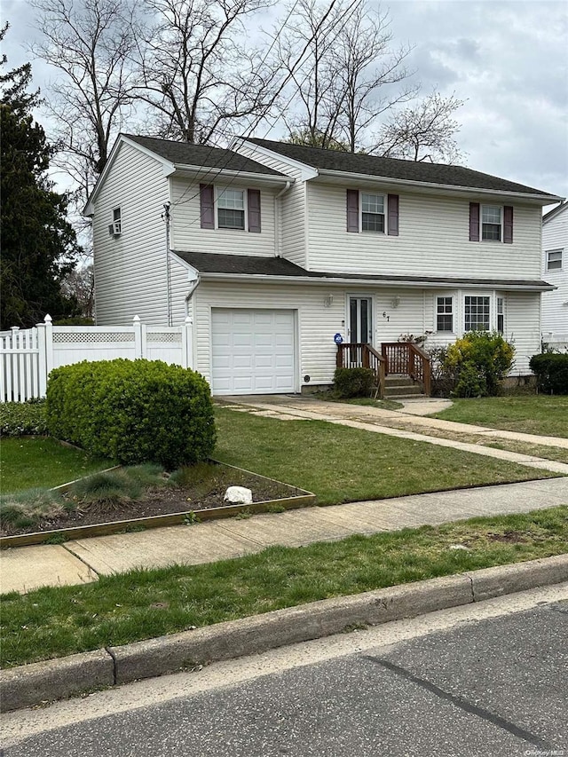 view of front of home with a garage and a front lawn