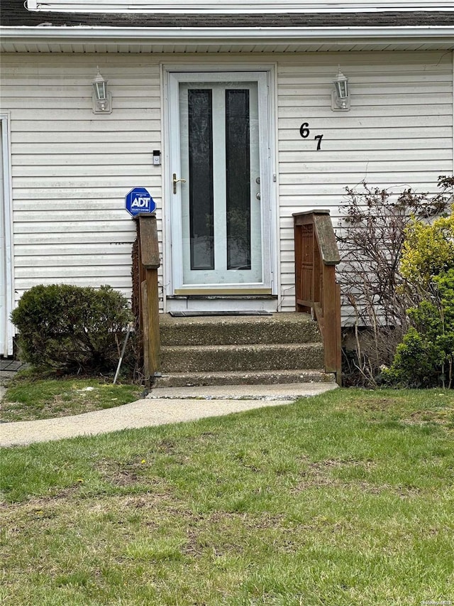 doorway to property featuring a yard