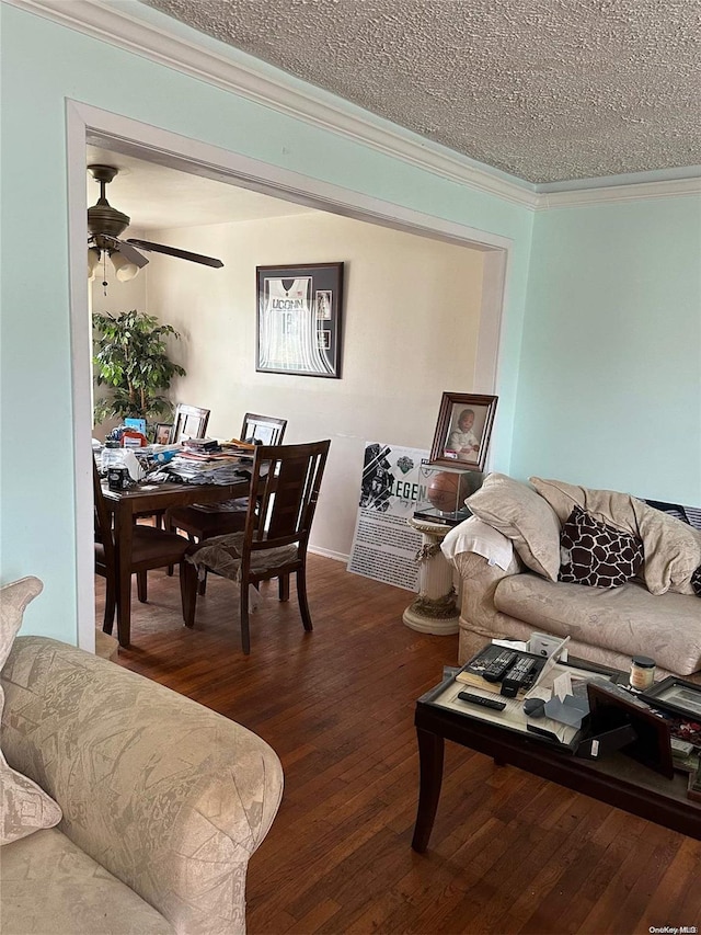 living room with hardwood / wood-style flooring, ceiling fan, crown molding, and a textured ceiling