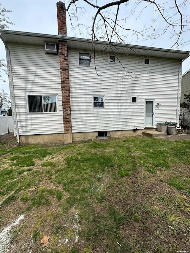 back of property with a yard