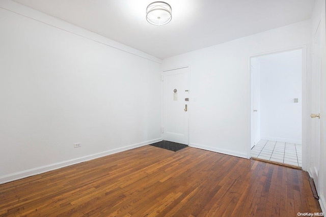 spare room with dark hardwood / wood-style flooring