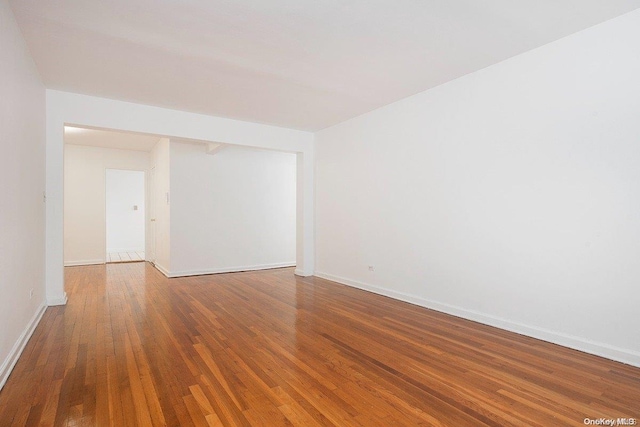 empty room with hardwood / wood-style floors