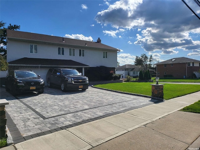 view of front of house featuring a garage and a front yard