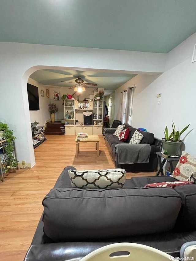 living room with hardwood / wood-style flooring and ceiling fan