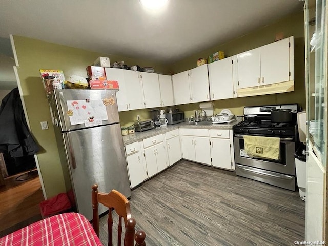 kitchen with sink, white cabinets, dark hardwood / wood-style floors, and appliances with stainless steel finishes