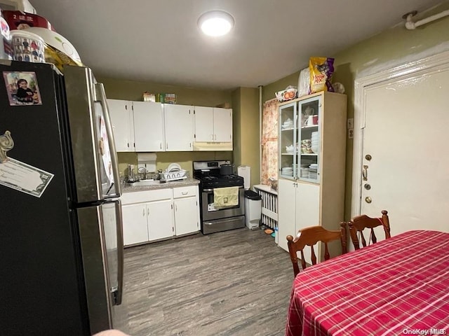 kitchen with white cabinetry, hardwood / wood-style floors, sink, and appliances with stainless steel finishes