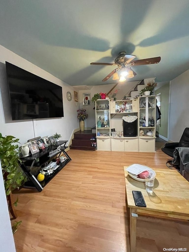 living room featuring ceiling fan and wood-type flooring