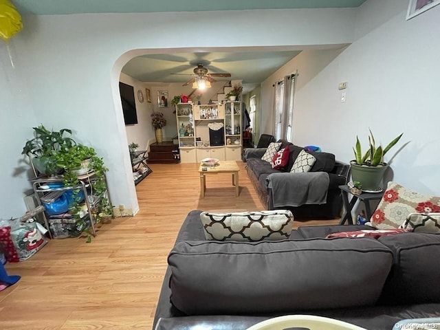 living room with ceiling fan and light hardwood / wood-style floors