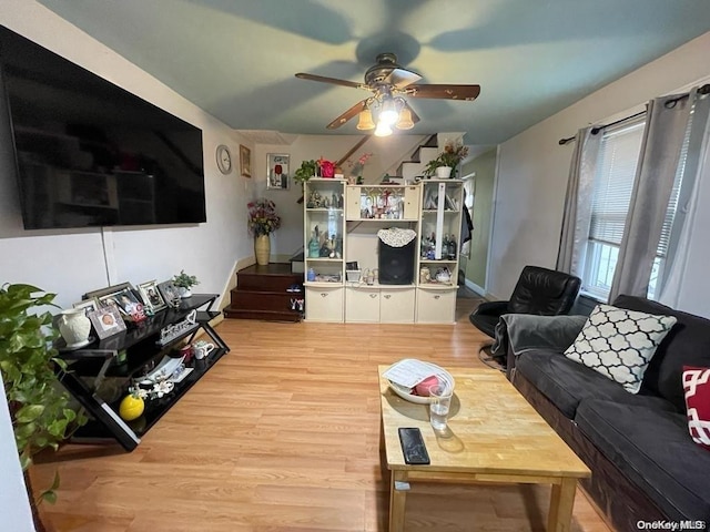 living room with hardwood / wood-style floors and ceiling fan