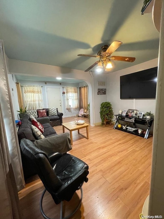 living room featuring ceiling fan and hardwood / wood-style flooring