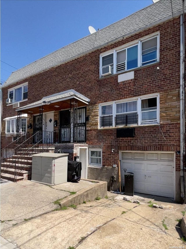 view of front facade with cooling unit and a garage