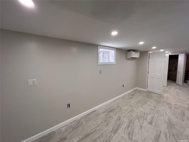 basement with a wall mounted air conditioner