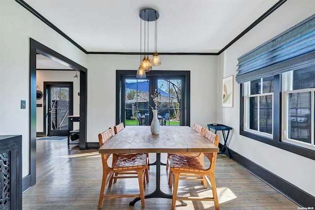 dining area with crown molding, hardwood / wood-style floors, and french doors