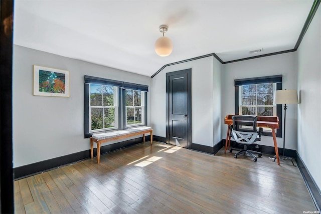 home office featuring dark wood-type flooring and ornamental molding