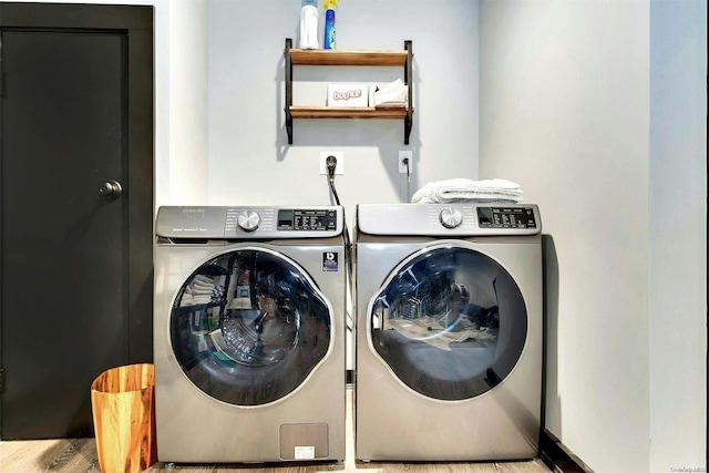 washroom featuring light wood-type flooring and washing machine and clothes dryer