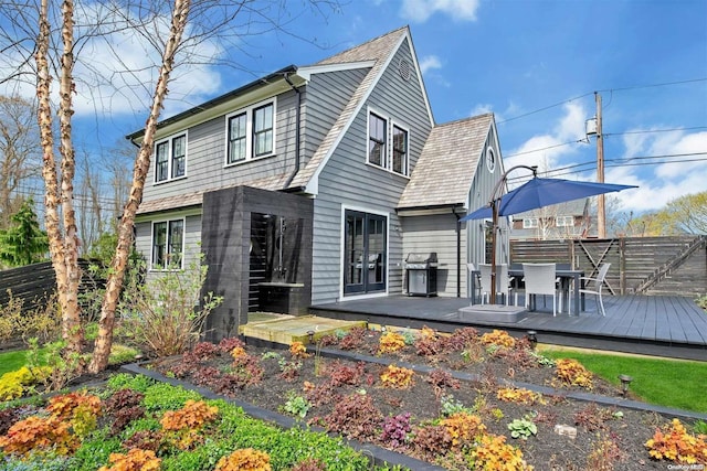 back of property featuring a wooden deck