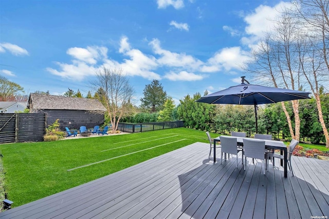 wooden terrace featuring a yard