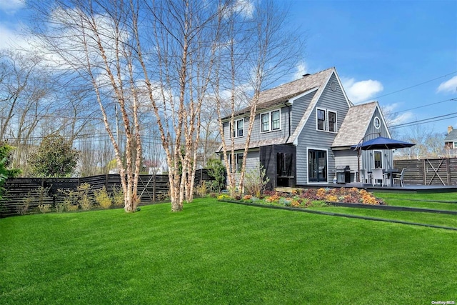 rear view of property with a yard and a patio area