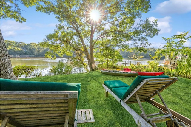 view of home's community featuring a water view and a yard