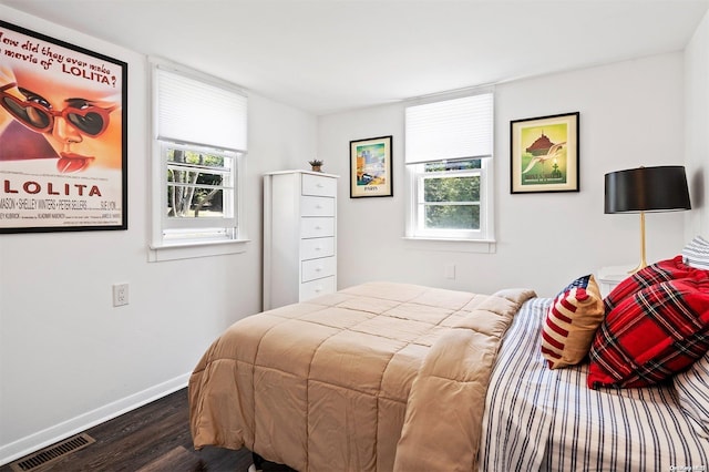 bedroom with dark wood-type flooring