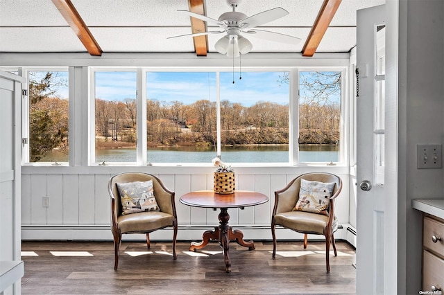 sunroom featuring ceiling fan, a water view, and a wealth of natural light