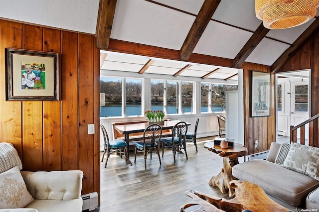 sunroom featuring vaulted ceiling with beams, a water view, and a baseboard radiator