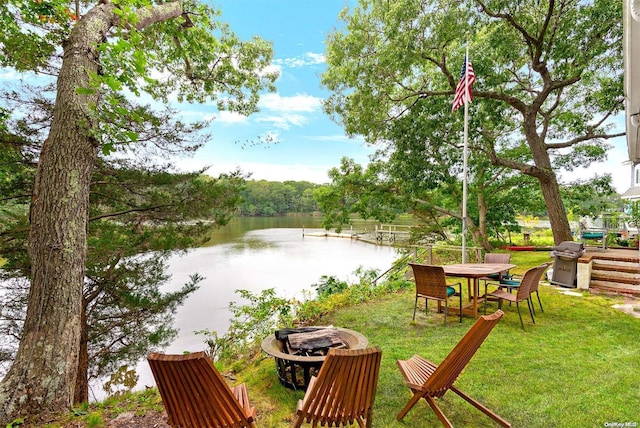 view of yard featuring a water view and a fire pit