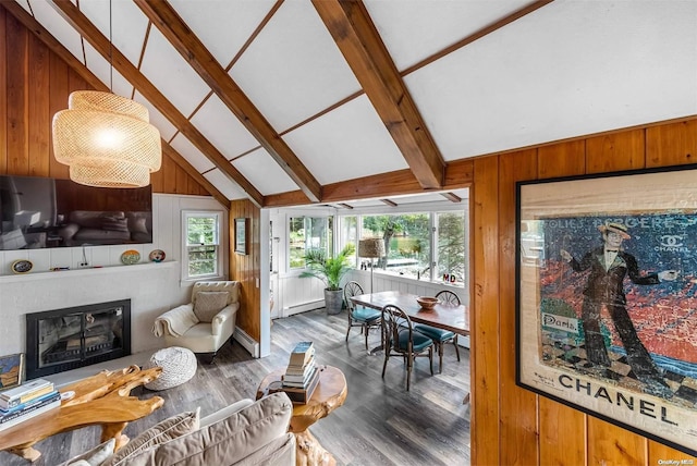 living room featuring wood walls, dark wood-type flooring, lofted ceiling with beams, and a baseboard heating unit