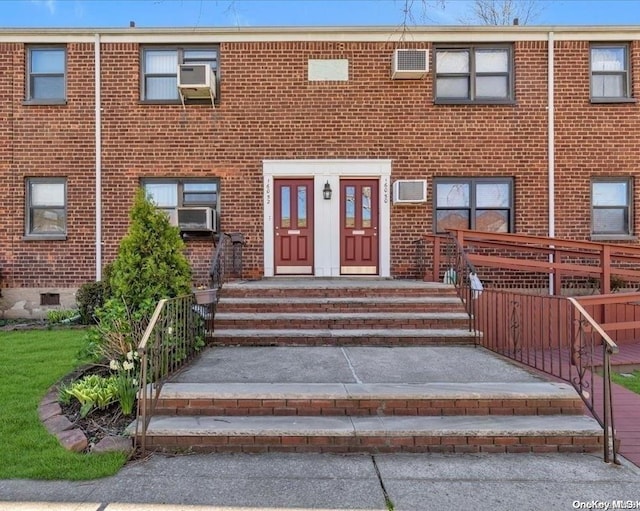 property entrance featuring cooling unit and a wall mounted air conditioner