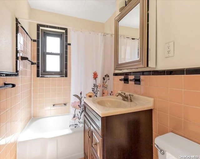 full bathroom featuring shower / tub combo, vanity, tile walls, and toilet