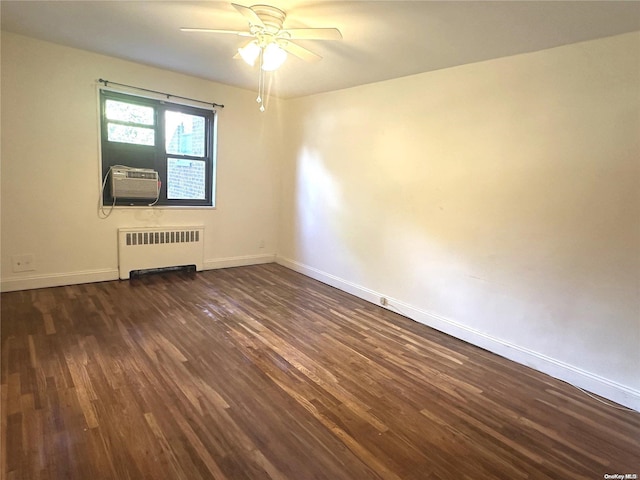 unfurnished room featuring radiator heating unit, dark hardwood / wood-style floors, ceiling fan, and cooling unit