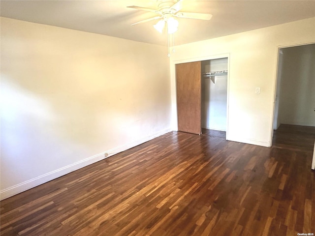 unfurnished bedroom with ceiling fan, dark hardwood / wood-style floors, and a closet