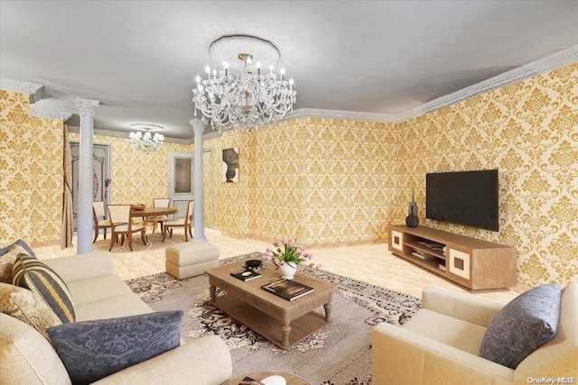 living room with hardwood / wood-style floors, an inviting chandelier, ornate columns, and crown molding