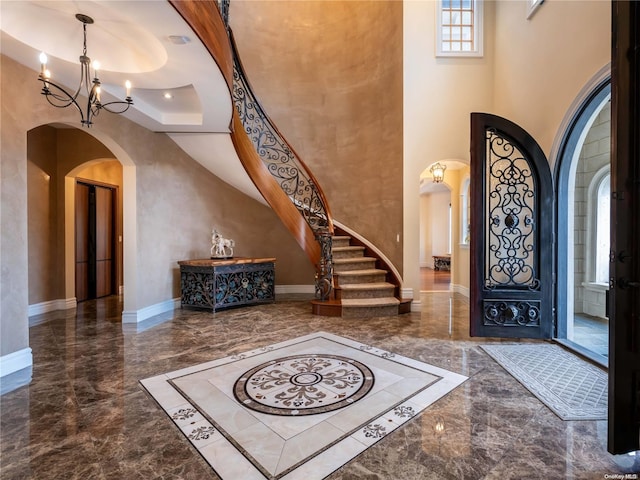 entryway featuring a chandelier and a high ceiling