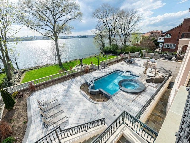 view of swimming pool featuring an in ground hot tub, a water view, and a patio