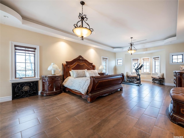 bedroom featuring a tray ceiling and dark hardwood / wood-style floors