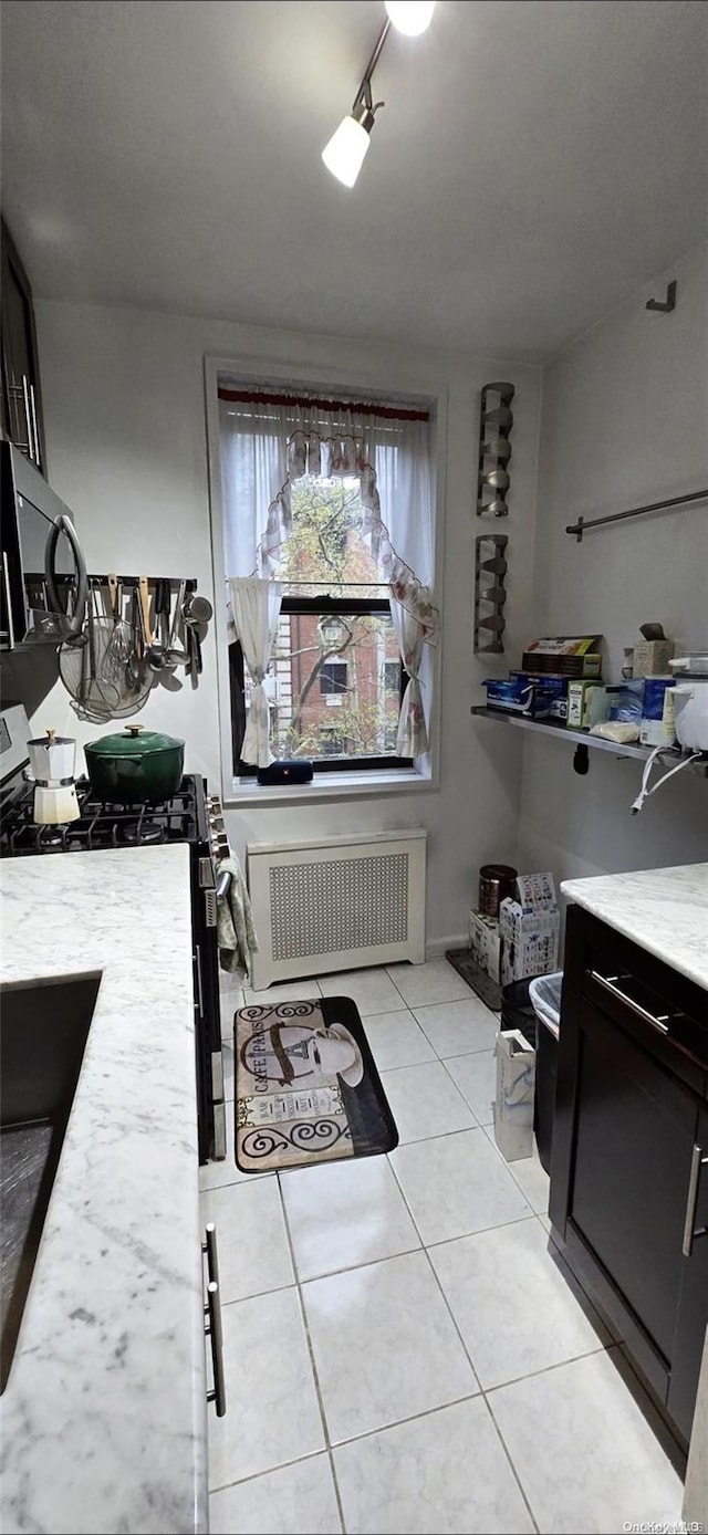 bathroom with tile patterned floors, vanity, and radiator heating unit