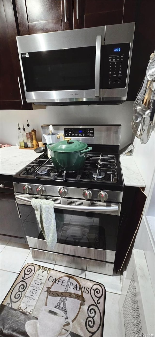 room details featuring dark brown cabinets and appliances with stainless steel finishes