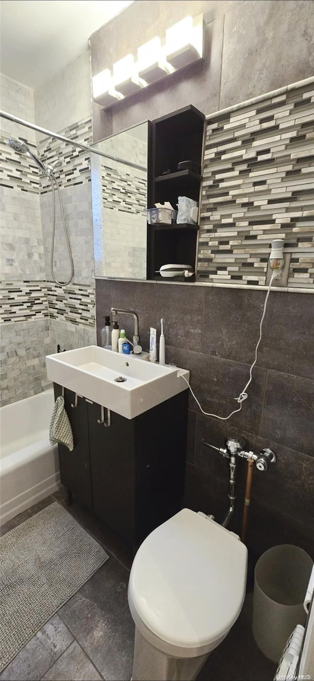 full bathroom featuring vanity, toilet, tile walls, and tasteful backsplash