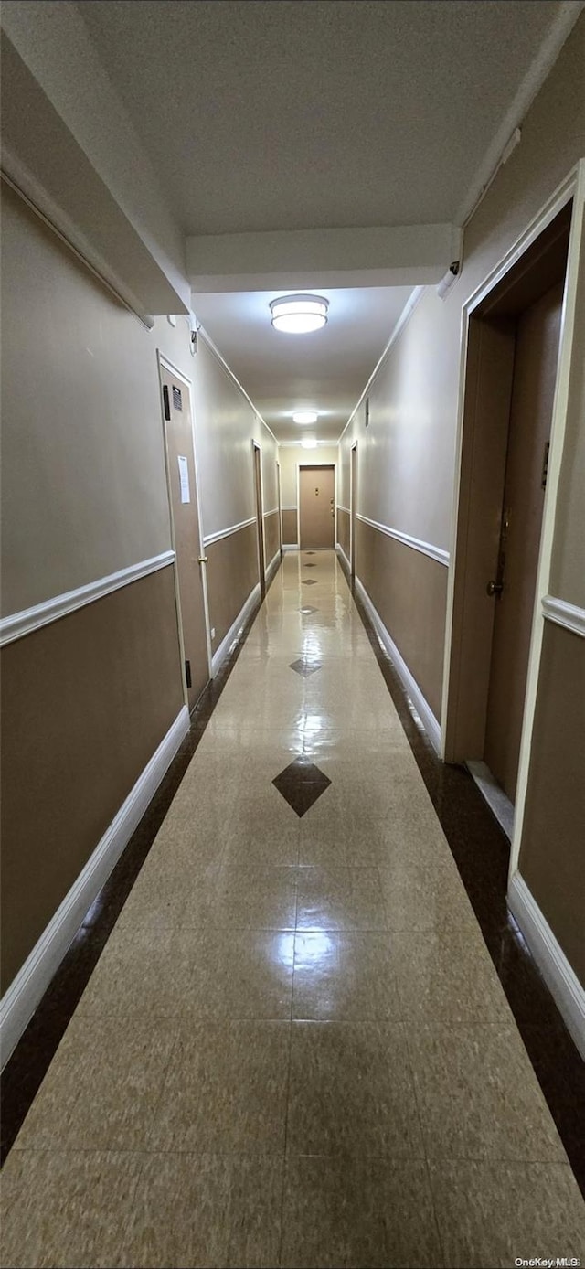 hall featuring a textured ceiling