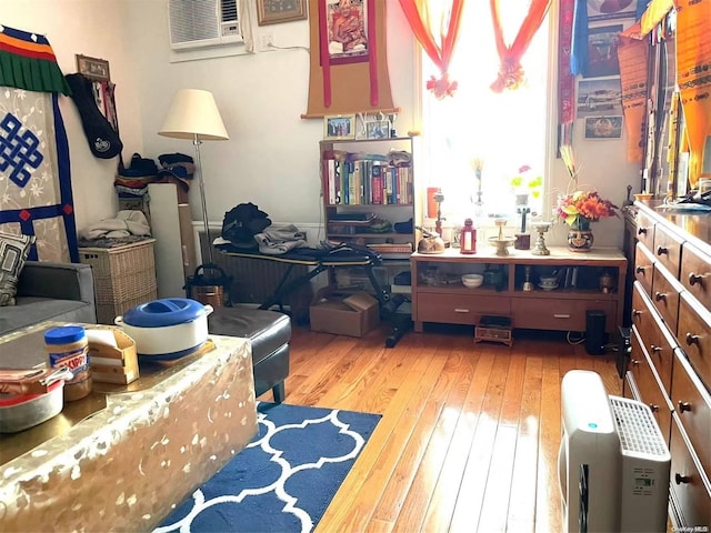 misc room featuring a wall mounted AC and hardwood / wood-style flooring