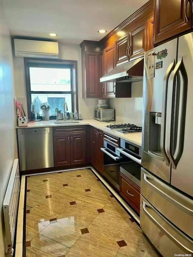 kitchen with a wall mounted AC, sink, and stainless steel appliances