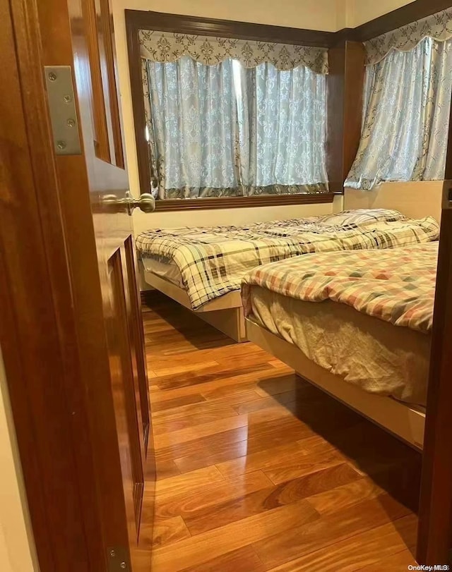 bedroom with wood-type flooring