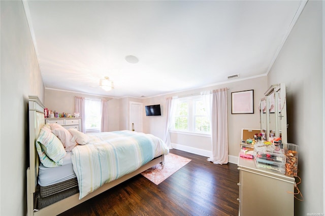 bedroom with dark hardwood / wood-style floors, multiple windows, and crown molding