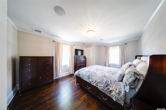 bedroom with dark hardwood / wood-style flooring and ornamental molding