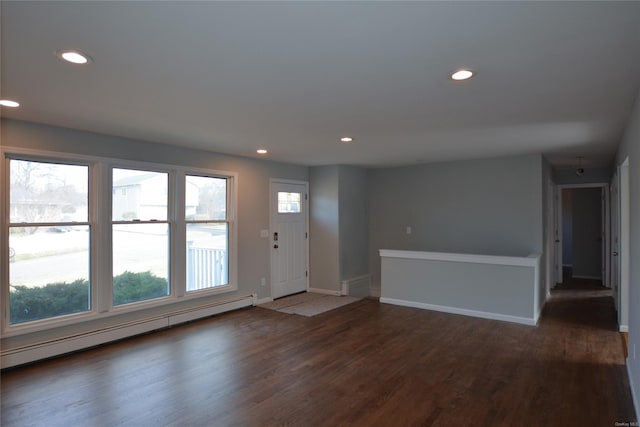 entryway with recessed lighting, plenty of natural light, baseboard heating, and wood finished floors