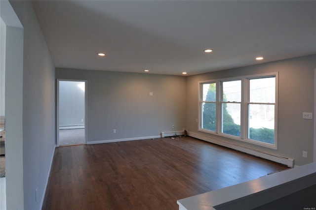 unfurnished room featuring recessed lighting, a baseboard heating unit, and dark wood finished floors