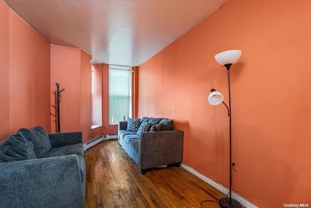 living room featuring baseboard heating and hardwood / wood-style floors