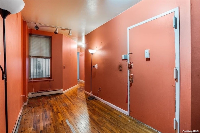 interior space featuring dark hardwood / wood-style floors and a baseboard heating unit